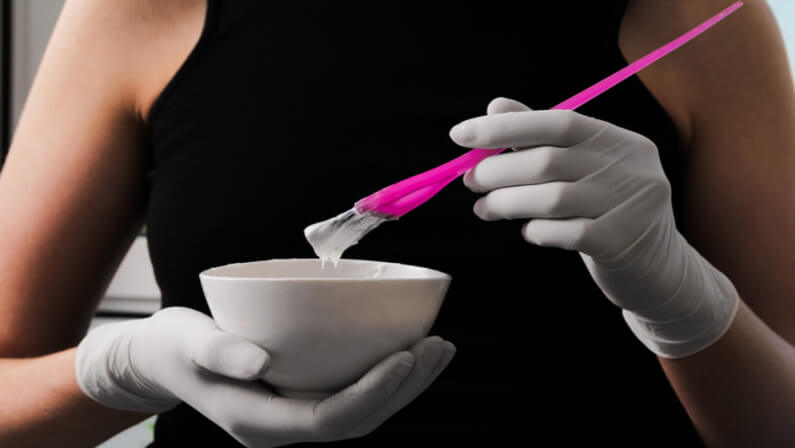 stylist holding bowl for hair color