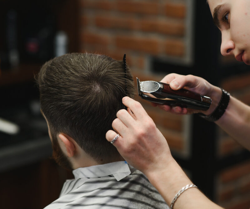 best hairstylist for men doing an updo to a man client