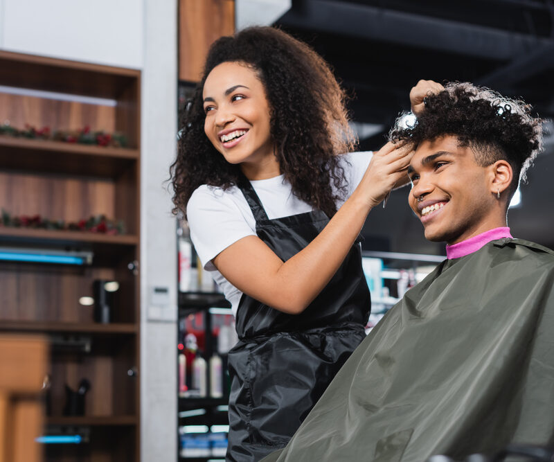 a good hairstylist doing updo to a client