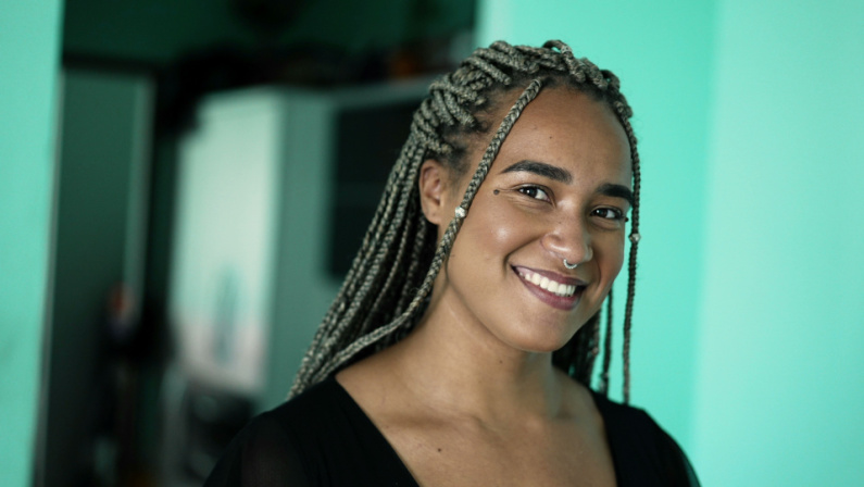 Portrait of a black latina woman with box draids hairstyle. A confident African girl face