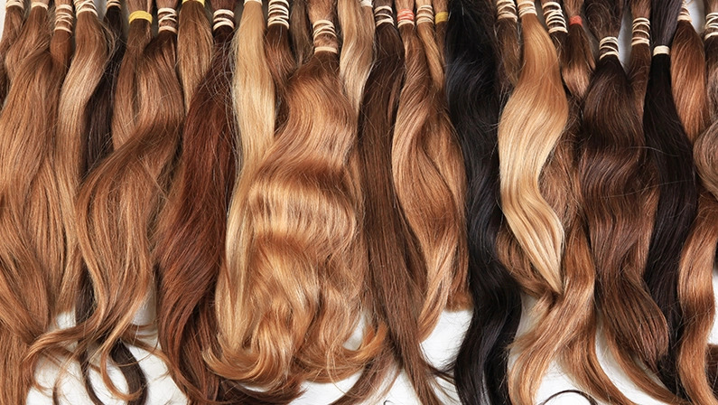 Hair extension equipment of natural hair. Hair samples of different colors