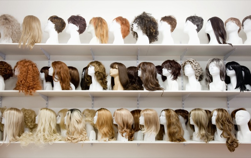 Row of Mannequin Heads with Wigs on the Shelf