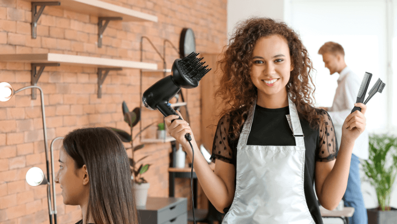 Young African-American hairdresser in beauty salon