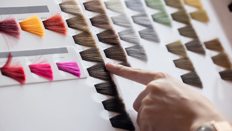 View of Woman Choosing Color from the Hair Color Chart For Hair Dye Concept